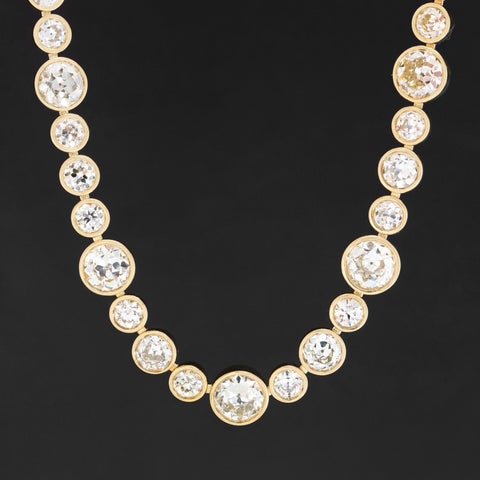 Riviere with bezel set old European cut diamonds in varying sizes in yellow gold.  The differing sizes give the piece a more contemporary feel yet so unique in that the diamonds are all vintage diamonds.