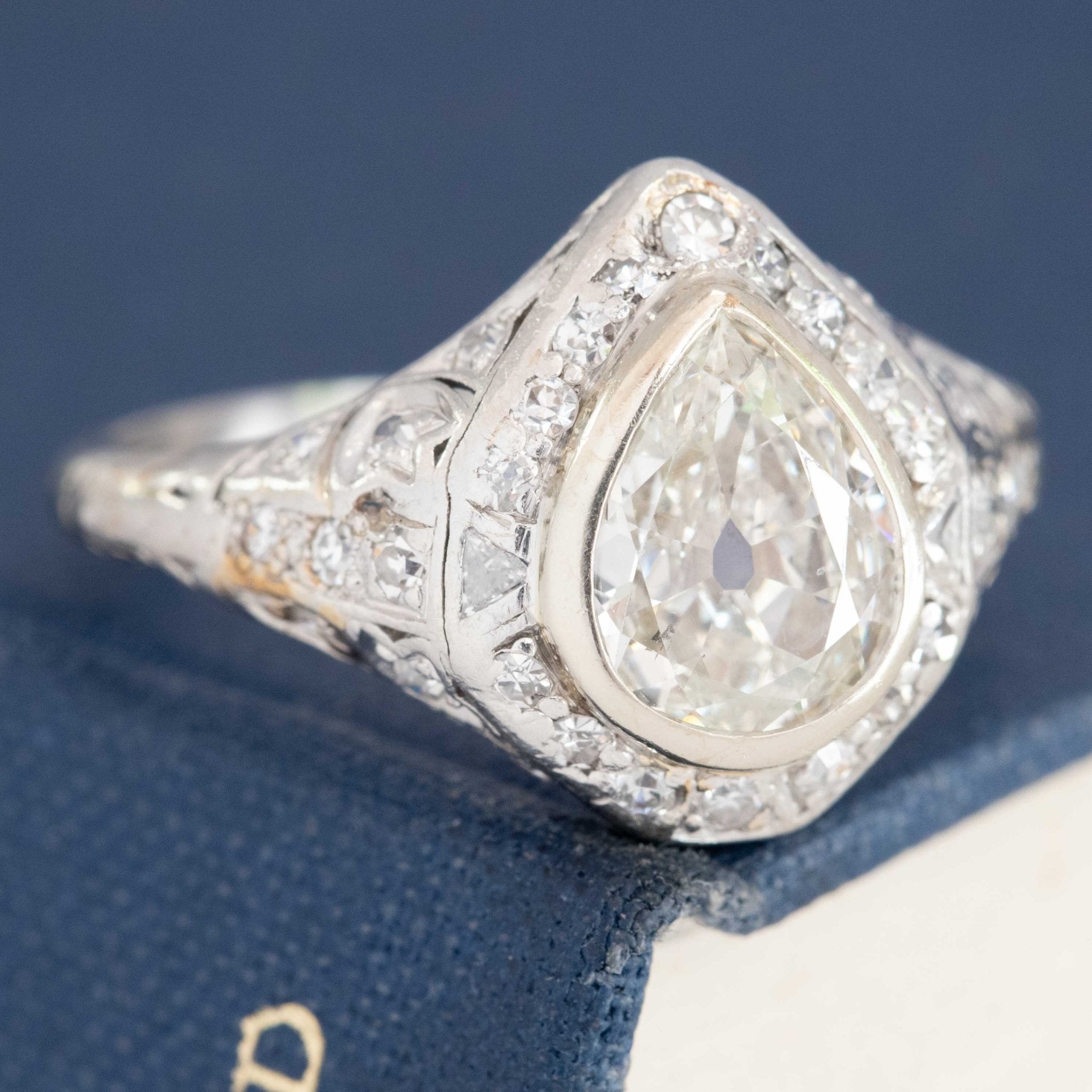 Antique platinum ring with pear diamond and old-cut halo