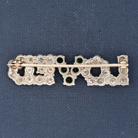 Decorative brooch with gemstones on a blue background