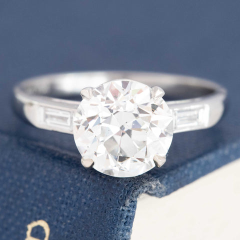 2.15ct GIA H SI2 old European cut diamond ring with hammer set baguette shoulders, platinum
