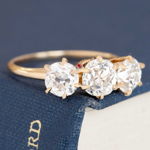 A antique 3-stone ring set with chunky old mine cut diamonds in a rosy yellow gold.  Perfect vintage engagement ring choice