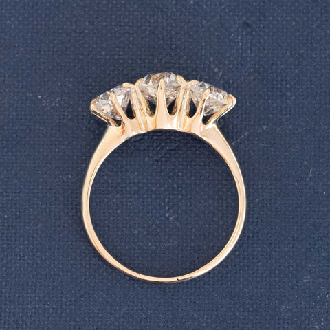 A antique 3-stone ring set with chunky old mine cut diamonds in a rosy yellow gold.  Perfect vintage engagement ring choice,