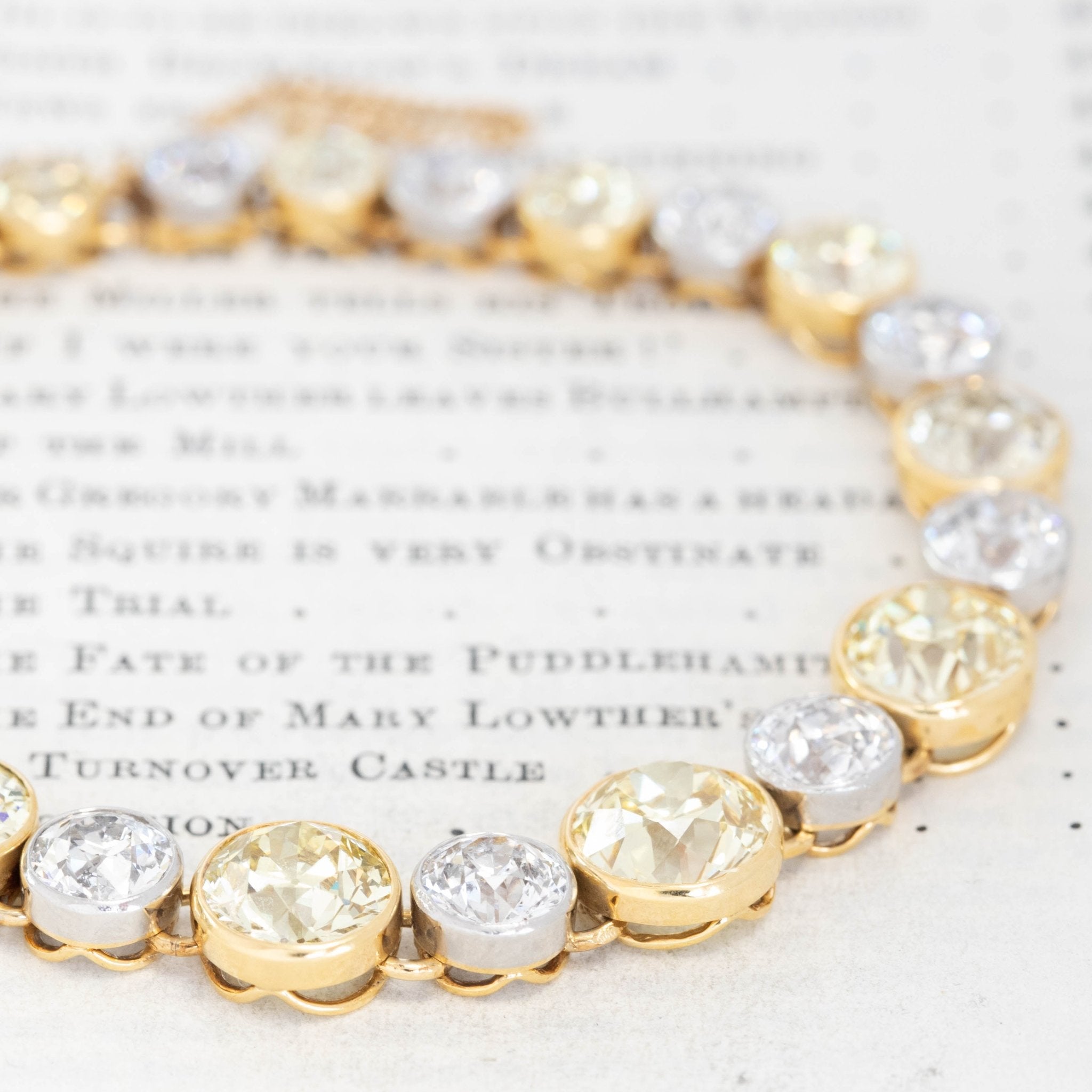 Close-up of old European cut fancy yellow diamond bezel settings in 18K yellow gold, antique estate bracelet by Black Starr and Frost