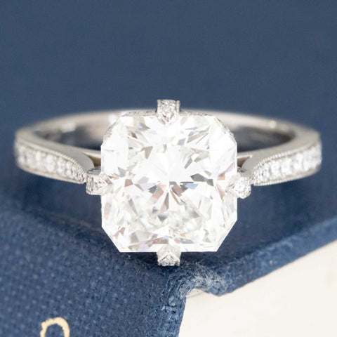 3.02ct Radiant Cut Diamond solitaire in platinum antique-inspired setting with pavé diamond details.