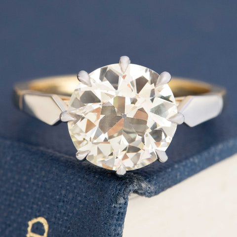 Old Mine Cut Diamond Ring, displayed on a book