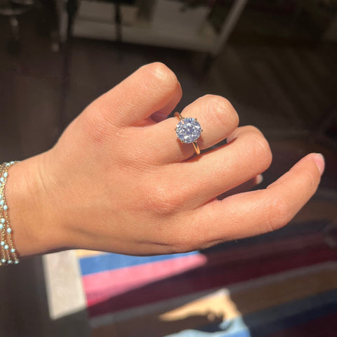 Chunky faceted Old European Cut diamond ring with flowery faceting shown on ring finger