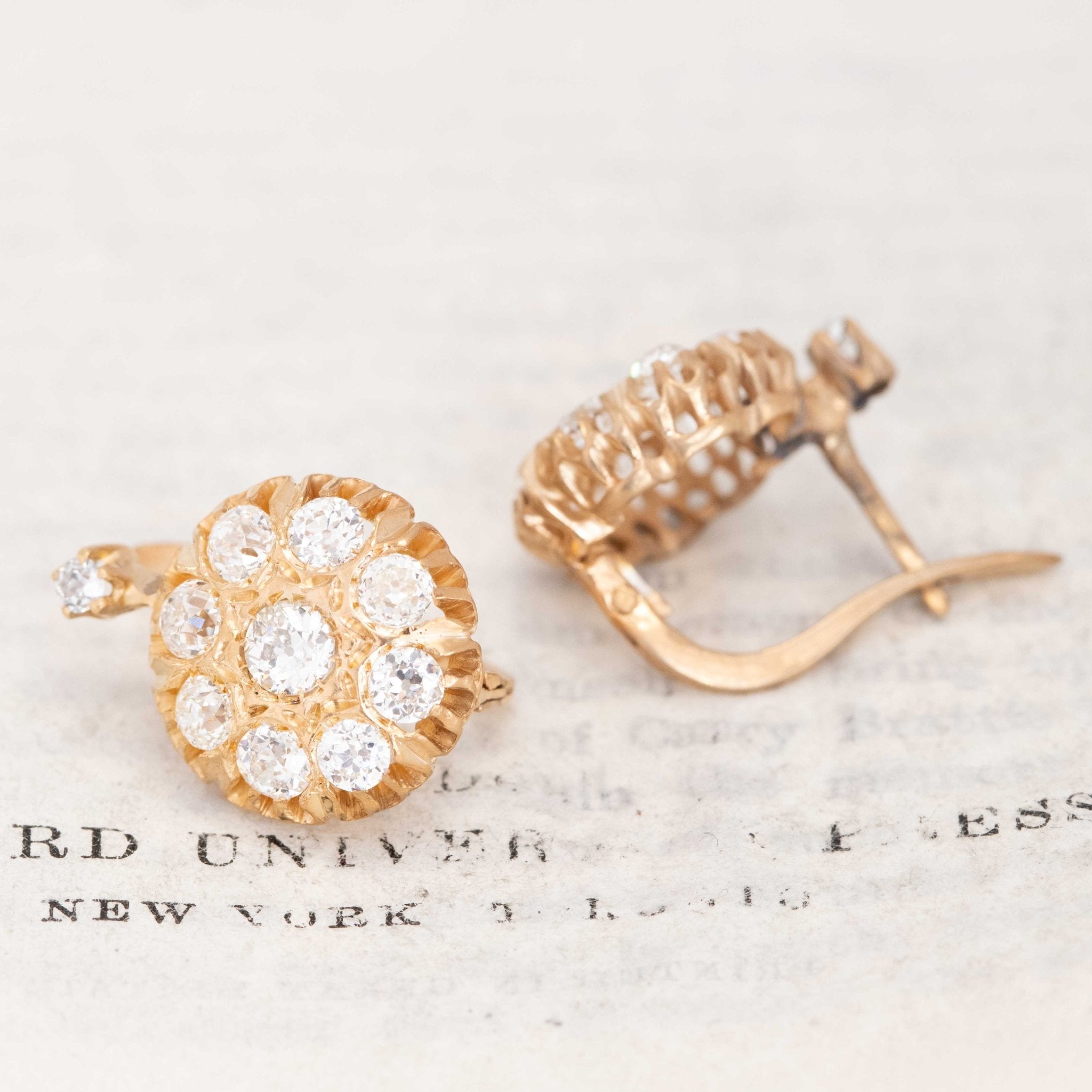 Close-up of vintage floral cluster diamond earrings in yellow gold