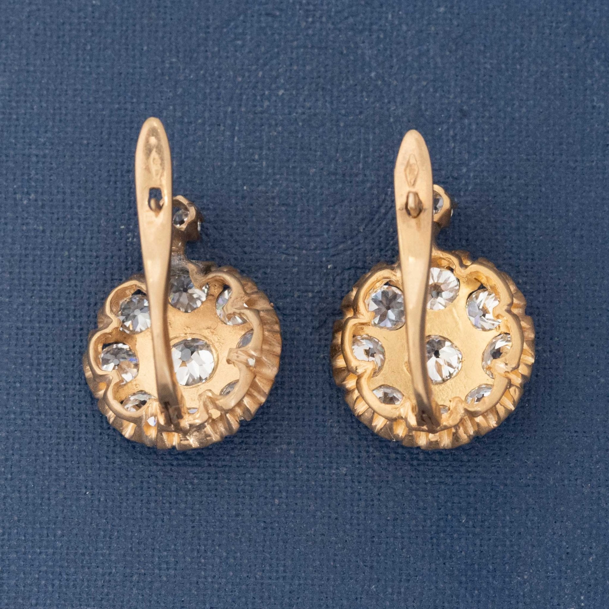 Old European cut diamond cluster earrings on antique paper background