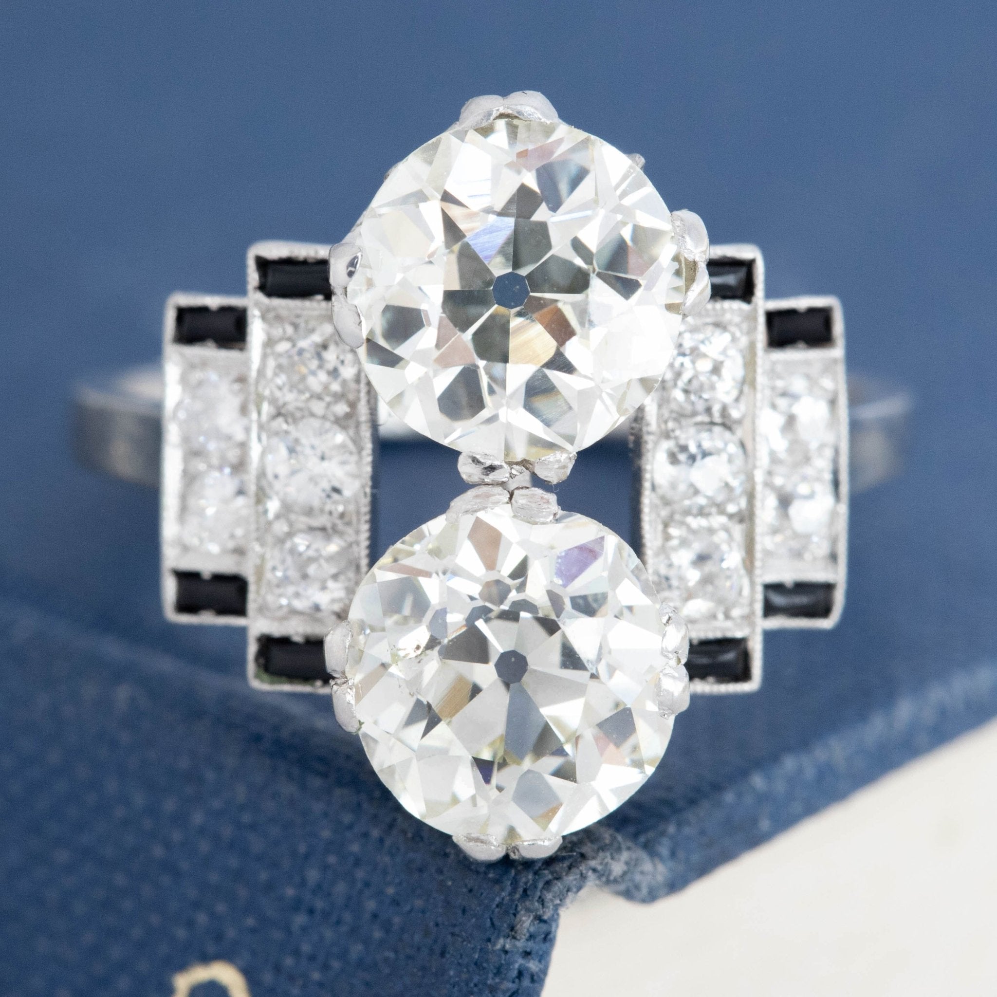 Antique black and white Art Deco diamond ring with milgrain detail