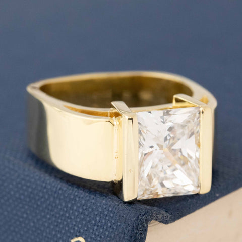 Bold yellow gold diamond ring with bright, sparkly princess cut center.
