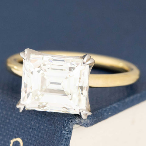 Antique emerald cut diamond ring with elegant flush-fit wedding band style.