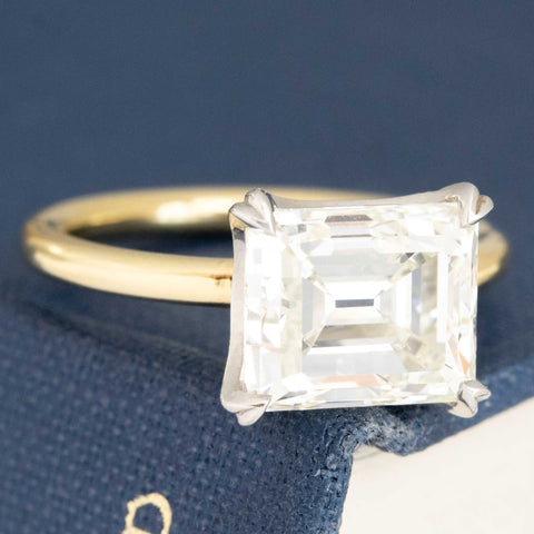Two-tone platinum and yellow gold antique emerald cut engagement ring.