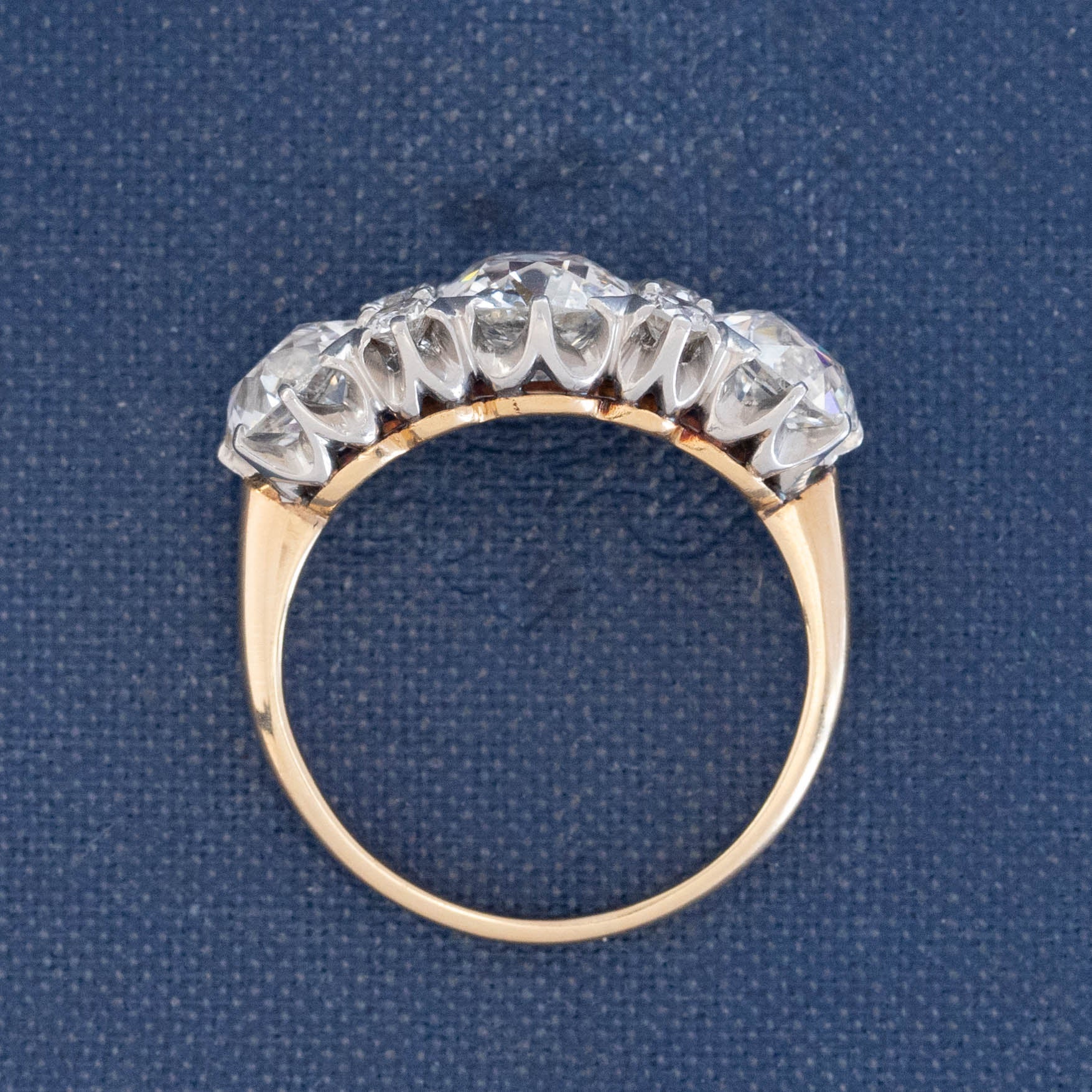 Antique two-tone gold diamond ring with old cut diamonds and scalloped white metal setting