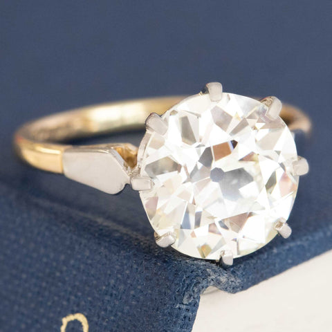 Antique two-tone diamond ring featuring Old Mine Cut diamond and detailed gallery.