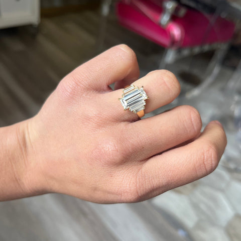 4.61ctw Antique Baguette Cut Diamond ring in 18kt yellow gold, GIA I VVS2 shown on ring finger