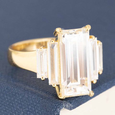 Vintage baguette diamond ring, crisp white face-up in yellow gold.
