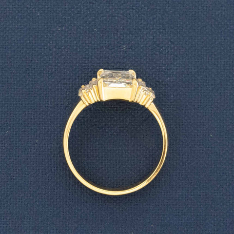Side view of reclaimed Art Deco baguette diamond in modern low-set setting.