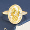4.70ct Fancy Yellow Oval Diamond bezel solitaire ring in yellow gold.