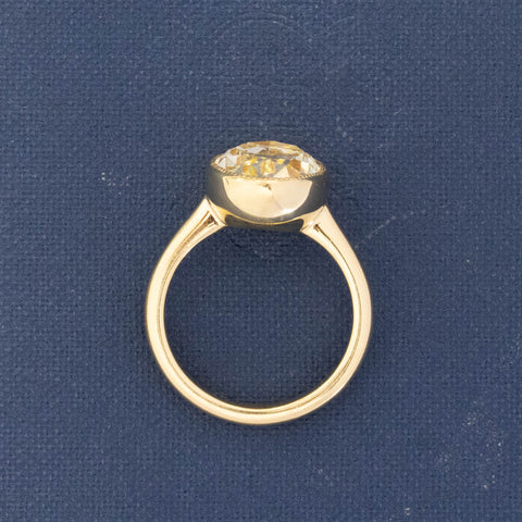 Side profile of Fancy Yellow Oval Diamond engagement ring with rich color and brilliance.