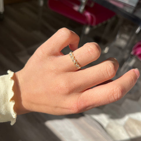 Elegant .47ctw Round Rose Cut Diamond Bezel Half-Hoop Band, romantic design with Antique Diamonds, Earth-mined diamonds in yellow gold shown on ring finger.
