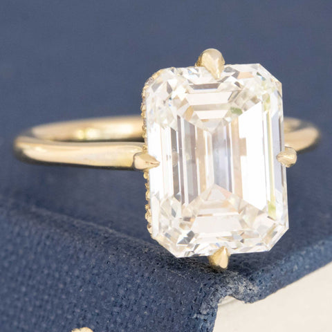 Classic yellow gold emerald cut diamond solitaire.