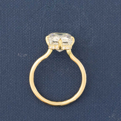 Side profile of elegant emerald cut diamond ring with crisp faceting.