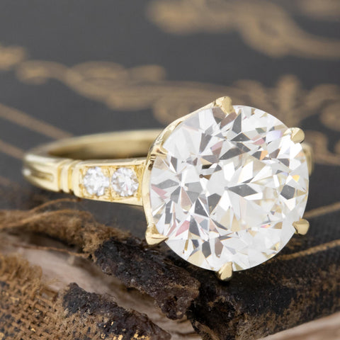 Antique-inspired transitional cut diamond ring with bead-set shoulders.