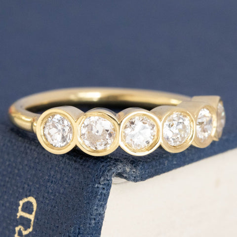 Close-up of .52ctw Old European Cut Diamond 6-Stone Bezel Band, vintage-inspired band with Old European Cut Diamonds, crafted in yellow gold.