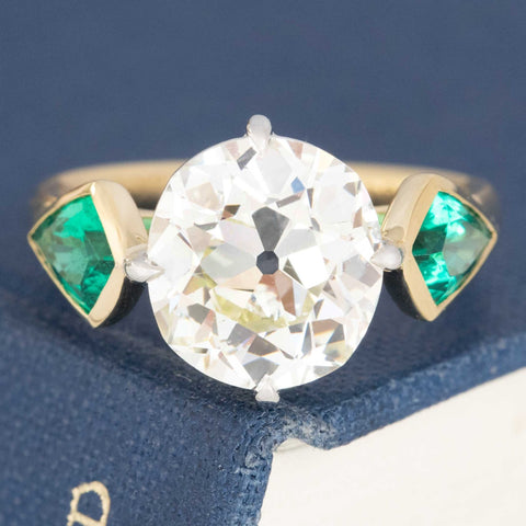 5.35ctw Old Mine Cut Diamond and Emerald trilogy ring in platinum and 18kt yellow gold.