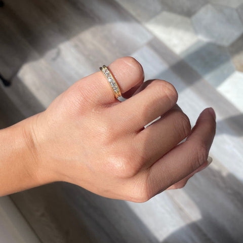 Elegant .58ctw Channel Set Old Mine Cut Diamond Band, romantic design with Old Mine Cut Diamonds, Earth-mined diamonds in yellow gold shown on ring finger.
