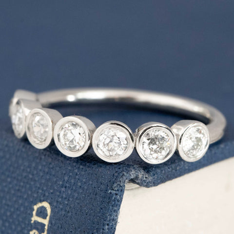 Antique lovers’ .62ctw Old European Cut Diamond 7-Stone Bezel Band in platinum, featuring rare Earth-mined Old European Cut Diamonds