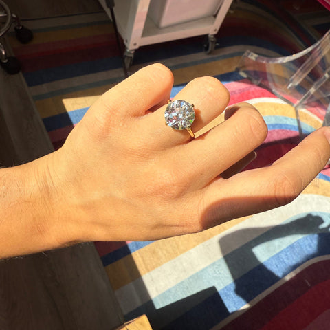 Old European cut solitaire diamond, prismatic antique sparkle shown on ring finger