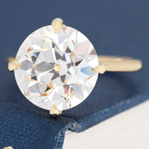 Vintage compass setting diamond ring in open gallery design.
