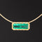 Emerald in gold collet setting on modern gold collar necklace