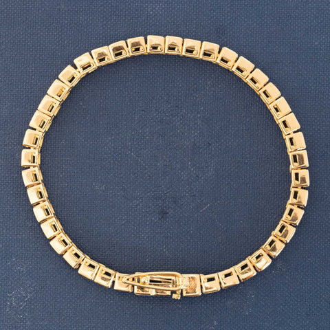 Detail of step-cut diamond faceting in 18kt yellow gold bezels