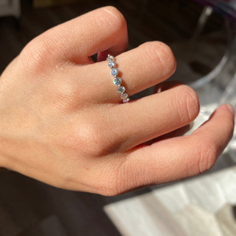 Elegant .74ctw Round Brilliant Cut Diamond Shared-Prong Band, romantic design with Antique Diamonds, Earth-mined diamonds in platinum shown on ring finger