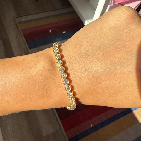 Full view of vintage-style diamond tennis bracelet on model. Antique diamond tennis bracelet sparkling in natural light