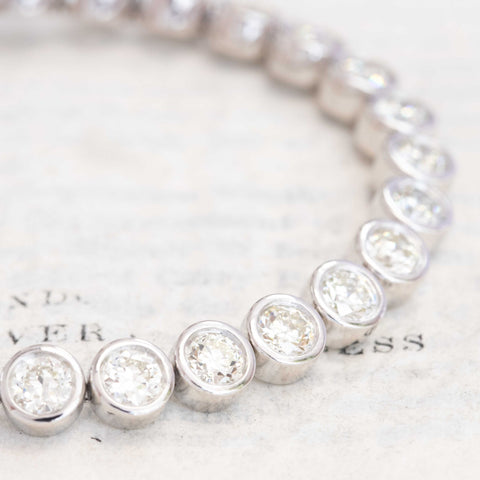 Close-up of antique Old European cut diamonds bezel-set in platinum. Detail of platinum bezels highlighting fiery diamond faceting and open culets