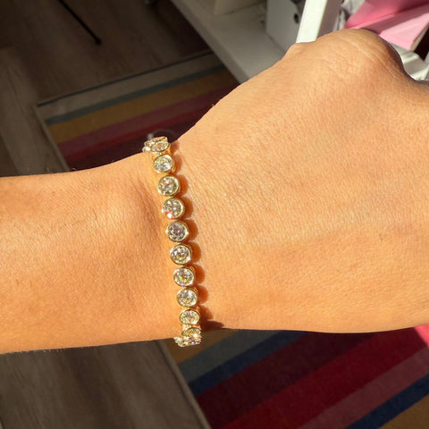 Close-up of recycled Old European cut diamonds bezel-set in yellow gold. Antique diamond tennis bracelet sparkling in natural light
