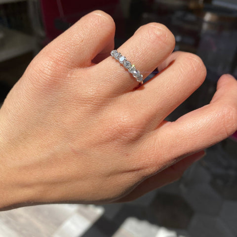 Elegant .83ctw Petite Old Mine Cut Diamond 7-Stone Band, romantic design with Old Mine Cut Diamonds, Earth-mined diamonds in platinum shown on ring finger