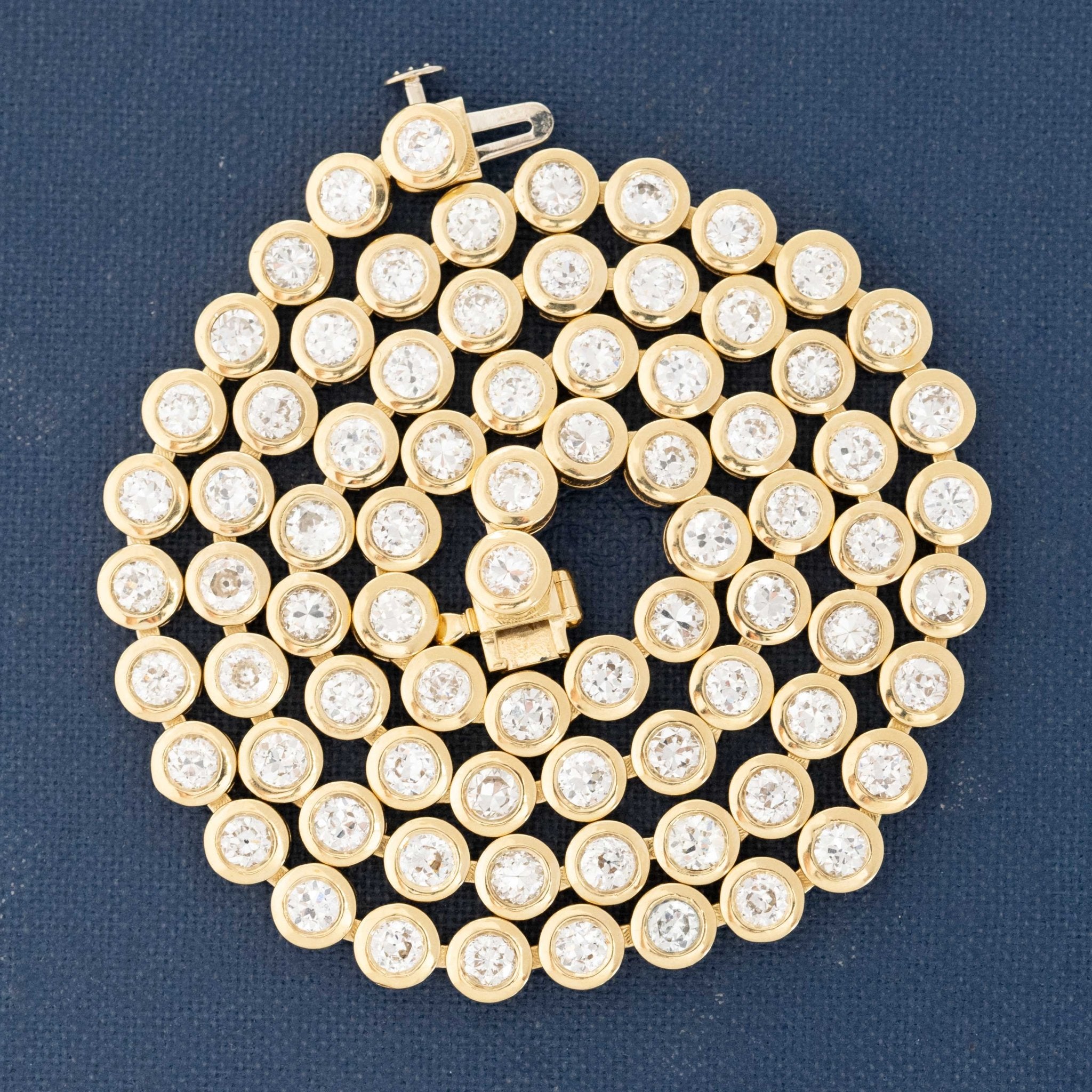 Close-up of 8.56ctw old-cut vintage diamonds set in a handcrafted 18kt Yellow Gold rivière necklace made in Los Angeles.