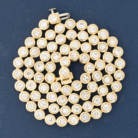 Close-up of 8.56ctw old-cut vintage diamonds set in a handcrafted 18kt Yellow Gold rivière necklace made in Los Angeles.