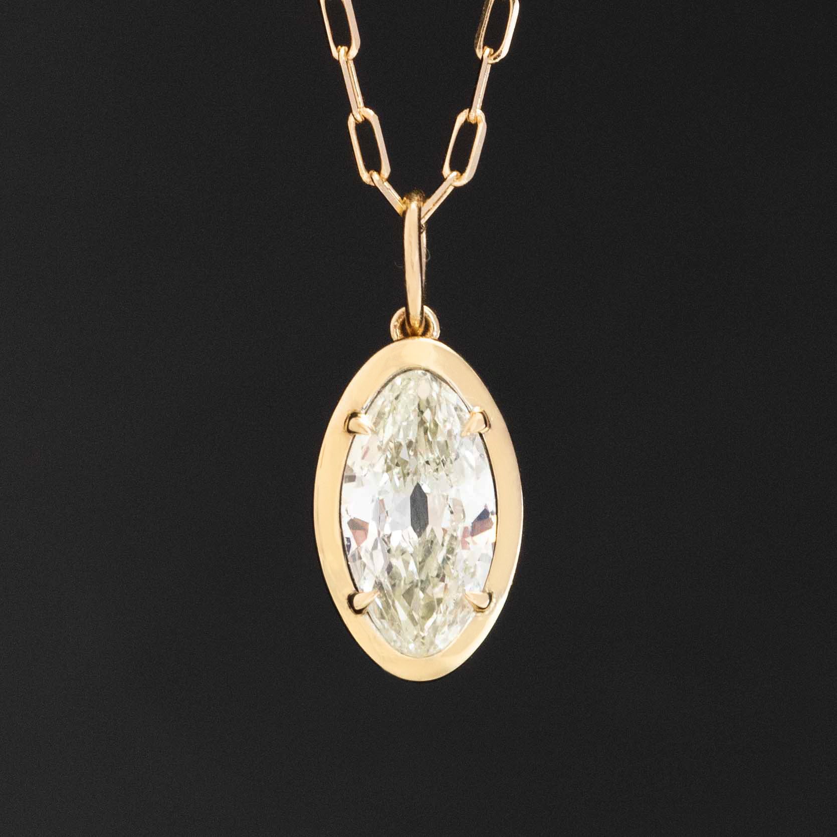 Vintage marquise cut diamond pendant necklace set in north–south orientation with 14k yellow gold chain.