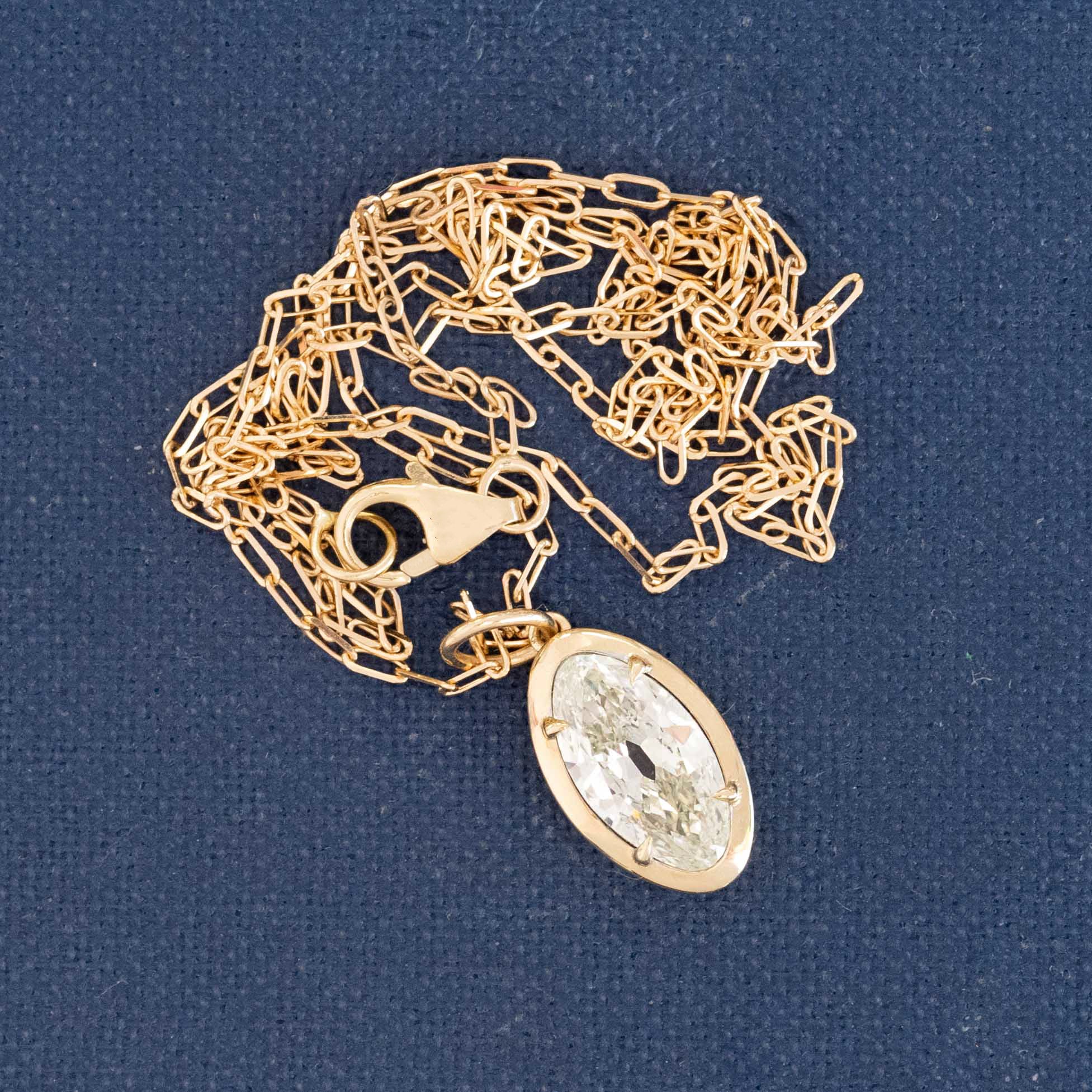 Antique-inspired marquise cut diamond pendant necklace, 14k gold chain, elongated north–south setting.