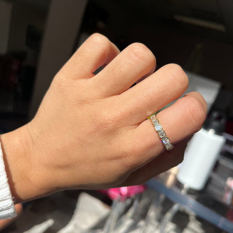 Elegant .89ctw Asscher Cut Diamond Bezel 7-Stone Band, romantic design with Antique Diamonds, Earth-mined diamonds in yellow gold shown on ring finger