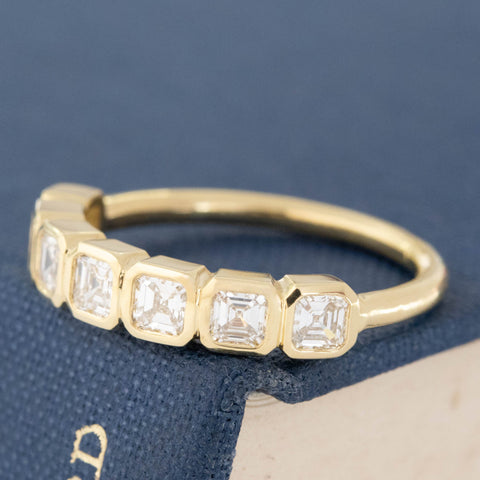 Antique lovers’ .89ctw Asscher Cut Diamond Bezel 7-Stone Band in yellow gold, featuring rare Earth-mined Antique Diamonds