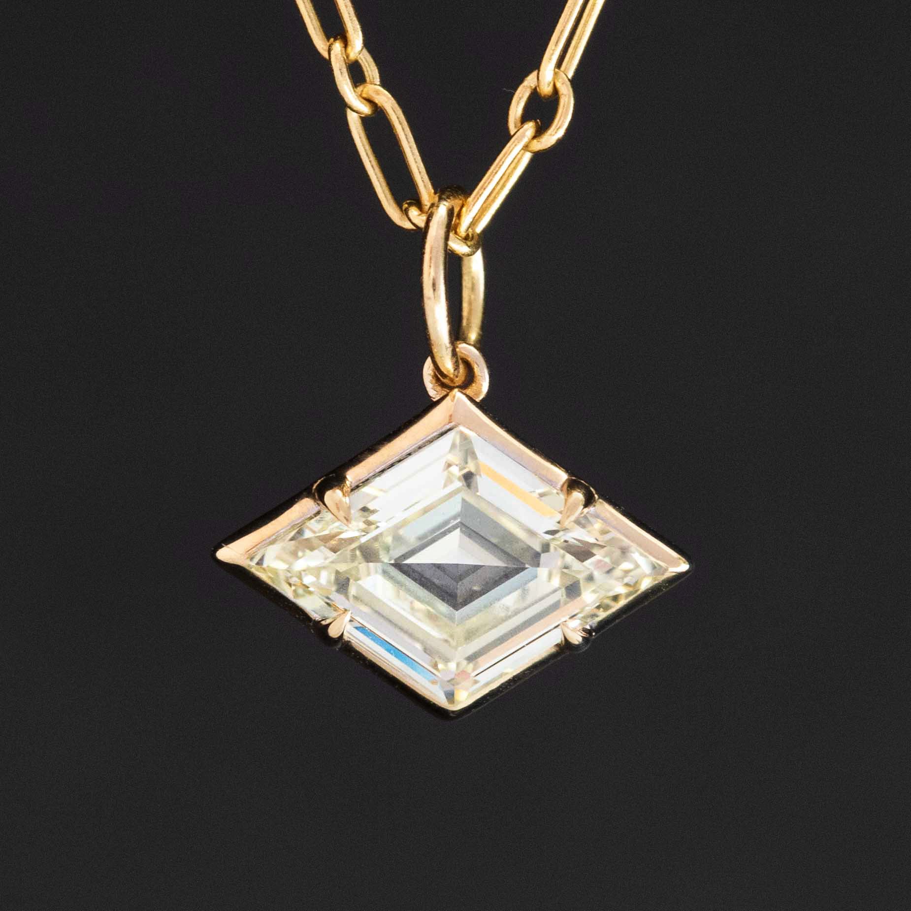 Close-up of rare kite-cut diamond set in white gold pendant, showing facets and sparkle