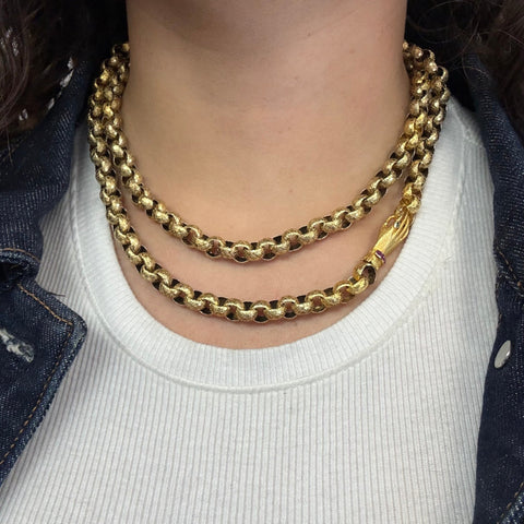 Antique long gold chain with celestial detail and symbolic hand clasp