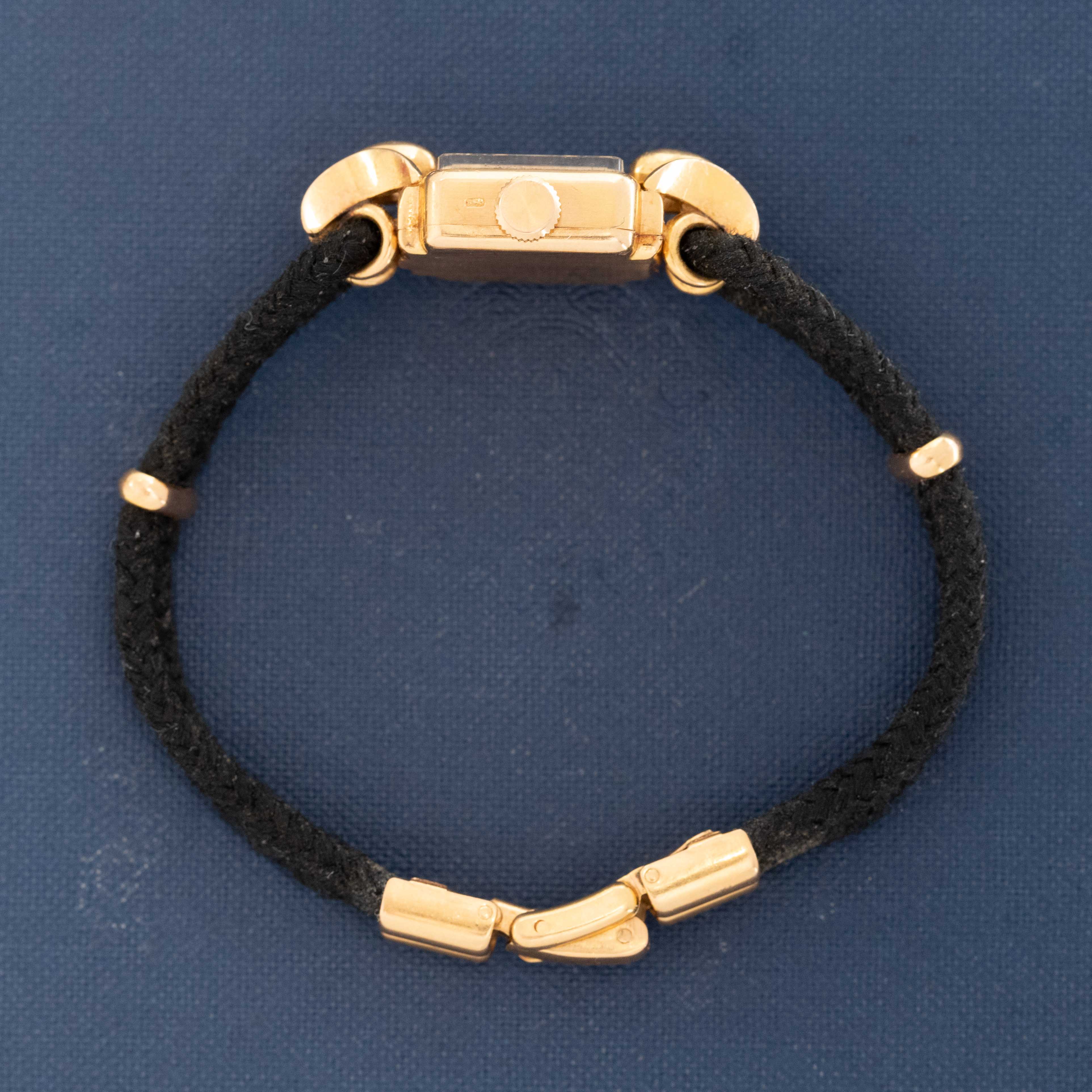 Collectible Patek Philippe watch resting on blue book