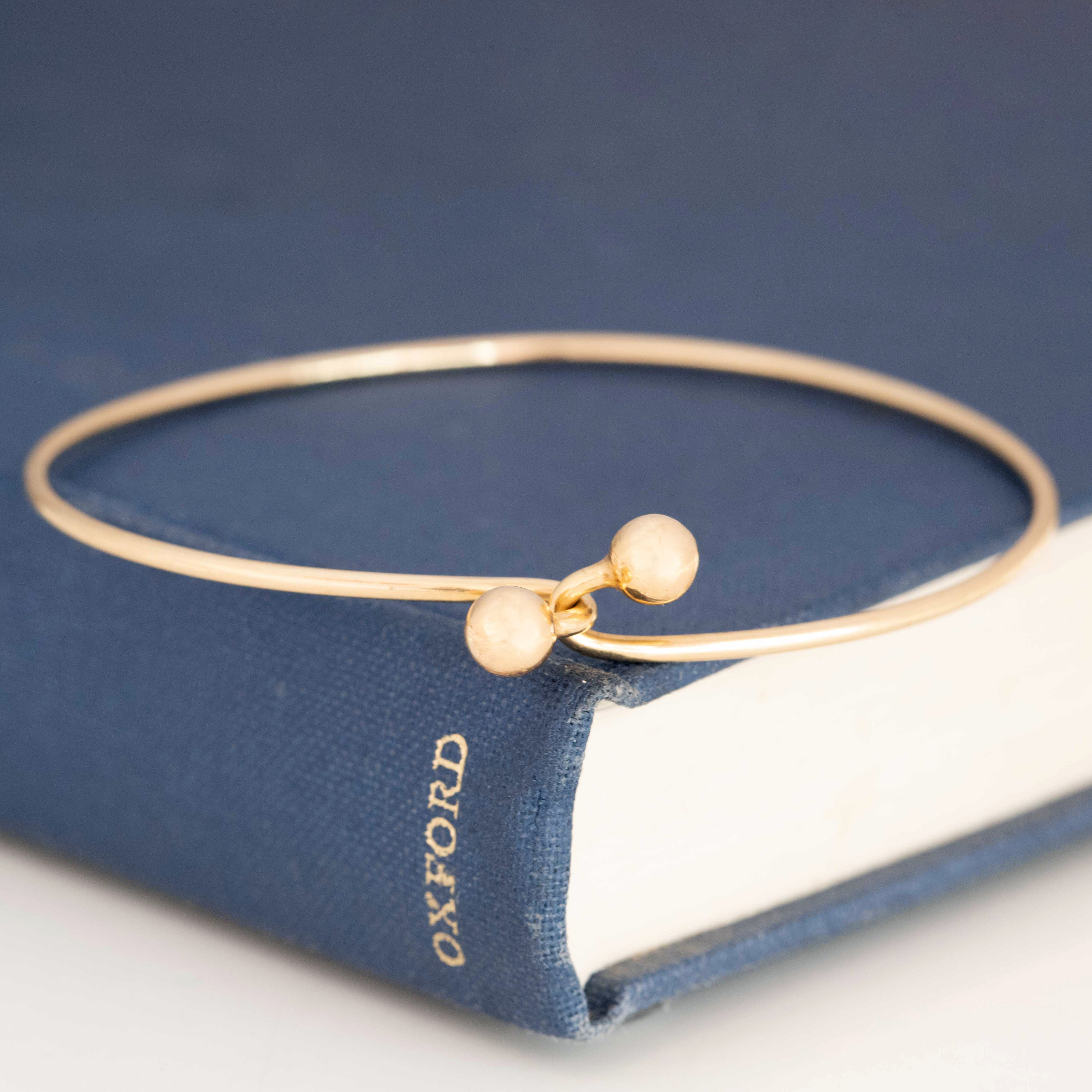 Vintage 14K gold bypass bangle with rounded ends